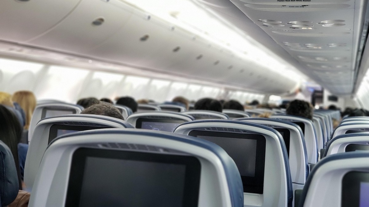 Woman gets violently sick on a 10-hour flight, and accidentally unlocks first class