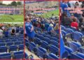 A video from a Duke football game shows many standing during a band performance. Then it highlights a group who stayed seated, The caption reads — stills from the TikTok posted by italian_cannoli_ravioli1